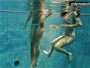 two beautiful amateurs flashing their figures off under water